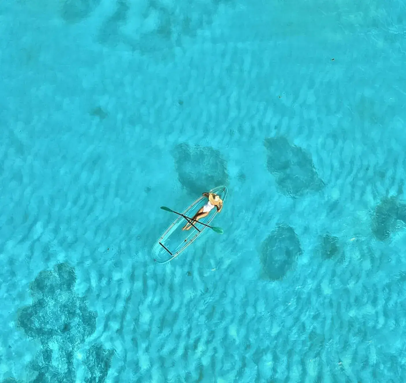 Clear kayak floating in turquoise Seychelles water